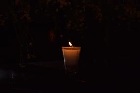 Sailing Visitation candle at dark