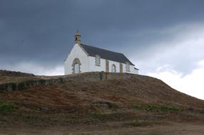 Beautiful church on the colorful hill, under the cloudy sky