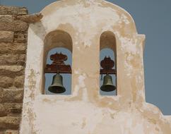 Beautiful bell tower of the church at blue sky background