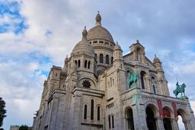 Beautiful, decorated SacrÃ© Coeur, at blue sky with white clouds on background, in Paris, France