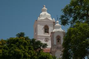 white Church with Bell Tower among trees, Portugal