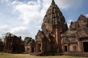 Beautiful, patterned Ta Pek Temple Complex in Thailand, under the blue sky, with white clouds