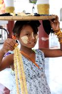 girl with a tray on her head