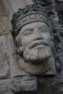 stone head of the king on the facade close-up