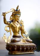 Statue Nepal Buddhism close-up on blurred background