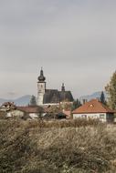 Beautiful small village with the chapel among the plants