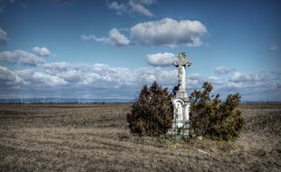 Wayside stone Cross in countryside, slovakia