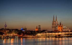 architecture of cologne reflected in water at dusk