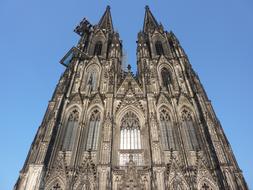 top part of Cologne cathedral facade at sky, germany