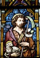 Beautiful and colorful stained glass church window with Jesus Christ with lamb