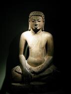 stone Buddha statue in shadow