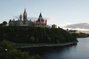 distant view of the temple complex on a hill above the river at dusk