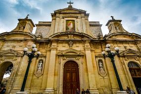 Beautiful and colorful cathedral in Mdina, Malta, under the blue sky with white clouds