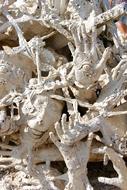 Hands Face Death stone statues