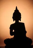 Buddha silhouette on the orange background
