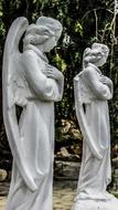 statues of angels in prayer in the garden