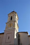 church bell tower with clock, bottom view