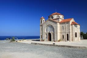 orthodox church on the shores of the mediterranean sea on a sunny day