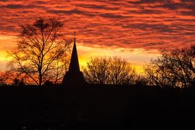 silhouette of a church spire at sunset