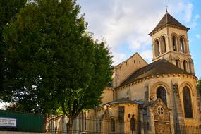 Beautiful church with fence and green trees in Paris, France