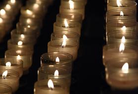 many candles for prayer in the dark