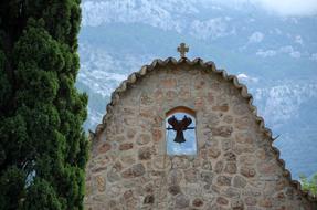 Bell Tower cross and green trees
