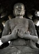 Buddha, aged grey stone sculpture