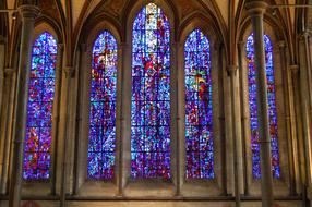 Beautiful and colorful, patterned stained glass window in the church, with the lights