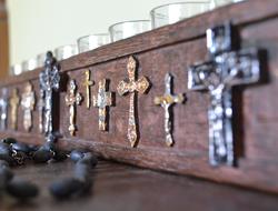 metal crosses on a wooden wall close up