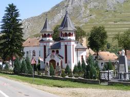 church near the road and mountain