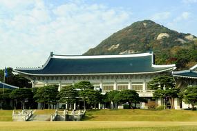 Beautiful and colorful temple, on the colorful mountains with trees in South Korea