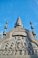 Beautiful sculpture with the patterns at blue sky with white clouds on background, in Cambodia