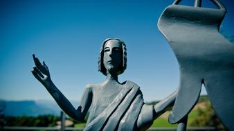 Figure Of Christ stone close-up on blurred background