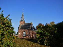 small church on a hill among the trees
