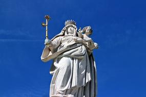 blue bright sky above the statue of the virgin mary