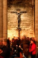 people in front of a large cross in a church in paris