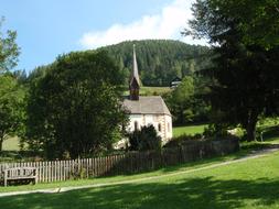 Beautiful landscape with the church, among the green plants, on the beautiful mountains in Bath Kleinkirchkeim, Carinthia, Austria