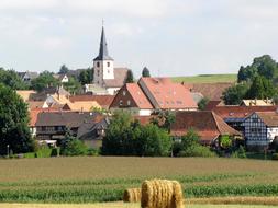 Beautiful and colorful landscape of Berstett, with the houses and church, among the plants, in rance