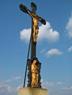 golden sculpture of jesus christ near the church