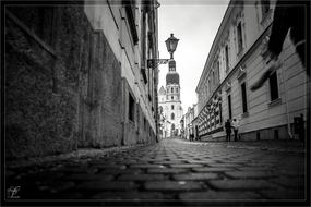 black and white photo of the street leading to the church