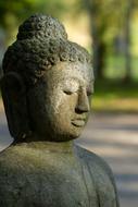 Stone Buddha Figure at sunlight