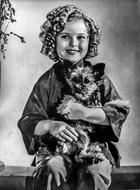 Black and white photo of the beautiful Shirley Temple, with the cute dog