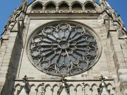 Beautiful, round window of the church, with pattern, at blue sky on background