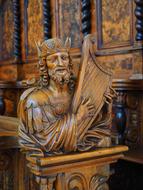 King plays Harp, aged wooden sculpture