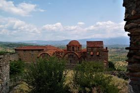 Beautiful, old church, among the colorful plants, in Mystras, Greece, on the landscape