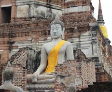 large buddha statue near a temple in thailand