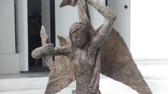 Old, colorful statue of the angel, in the white church