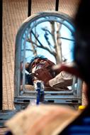 Barber with the mirror in Vrindavan, India, near the trees