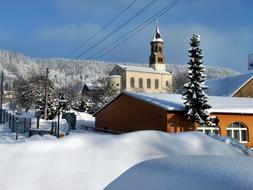 Beautiful landscape with the Saupsdorf Church among the plants, in snow, in the beautiful winter