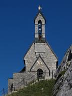 Beautiful church on the Wendelstein with green grass, in Bavaria, Germany, under the blue sky